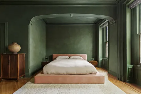 a bedroom with a bed and lamp