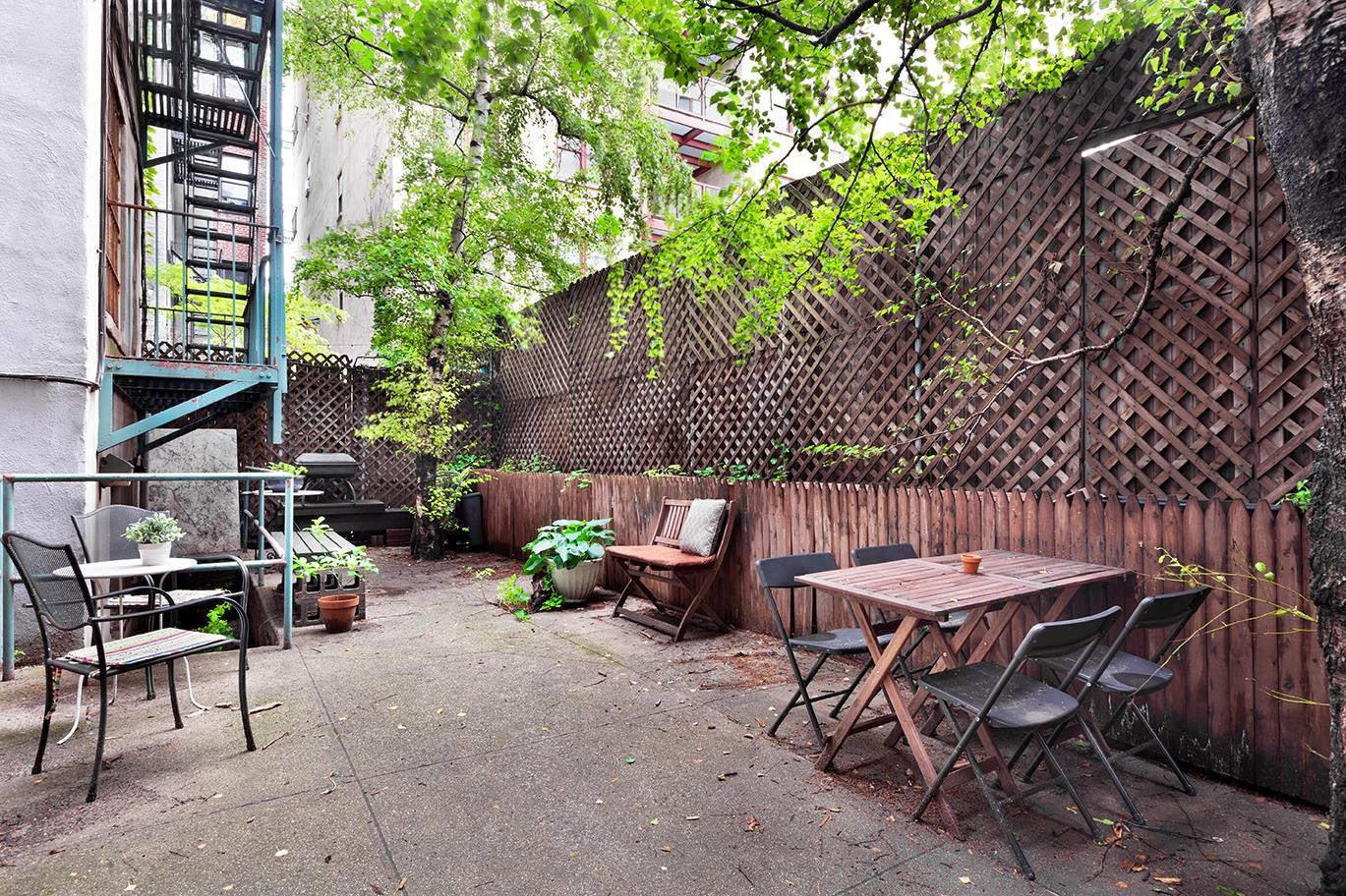 99 Avenue B, Unit 1B Manhattan, NY 10009 - Photo 7 of 8 a view of a patio with table and chairs and potted plants