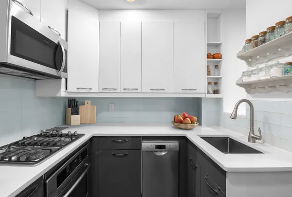 a kitchen with stainless steel appliances granite countertop a sink and a stove