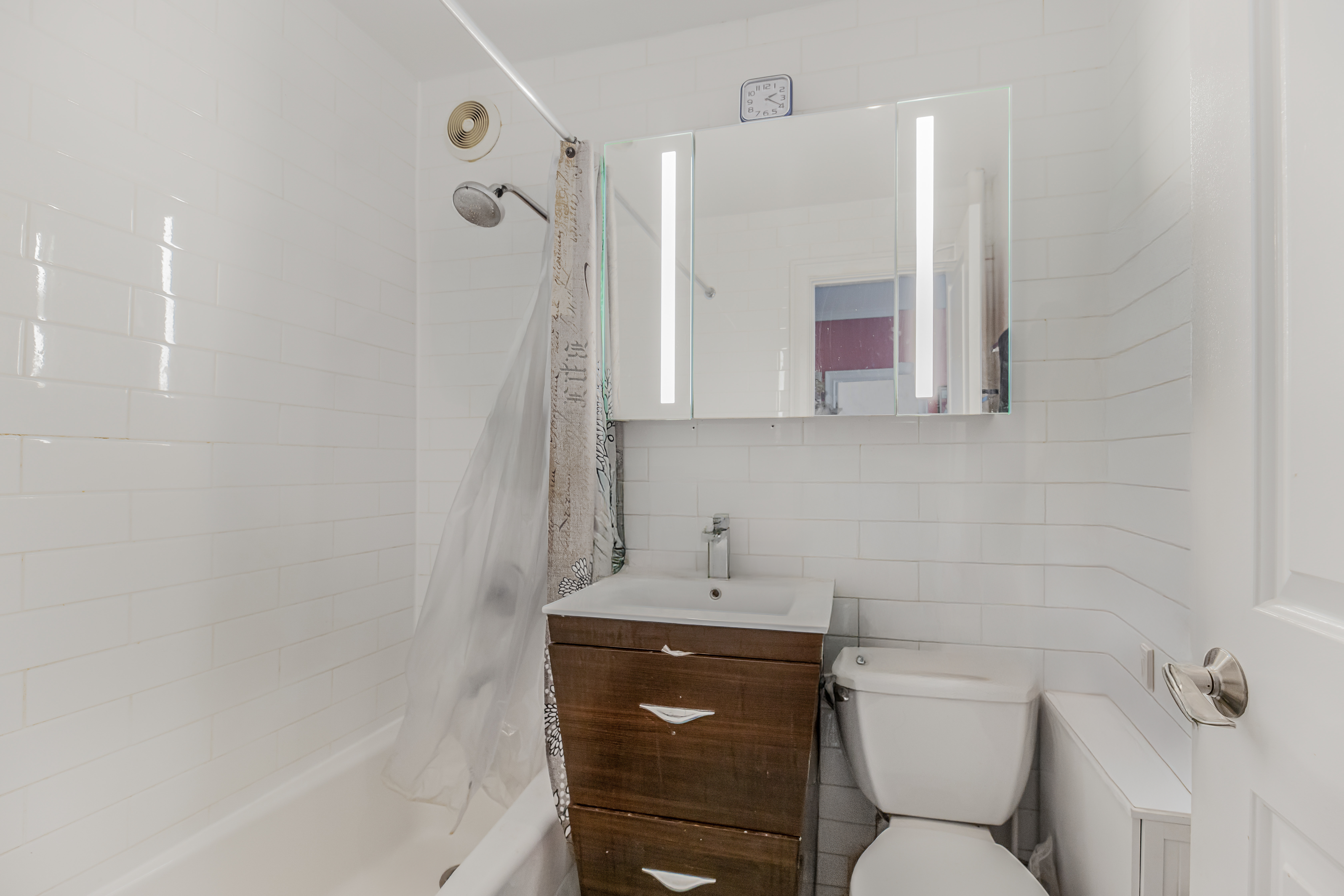 660 Riverside Drive, Unit 4J Manhattan, NY 10031 - Photo 5 of 7 a bathroom with a toilet sink and mirror