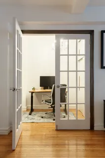 a view of a livingroom with a flat screen tv and a window