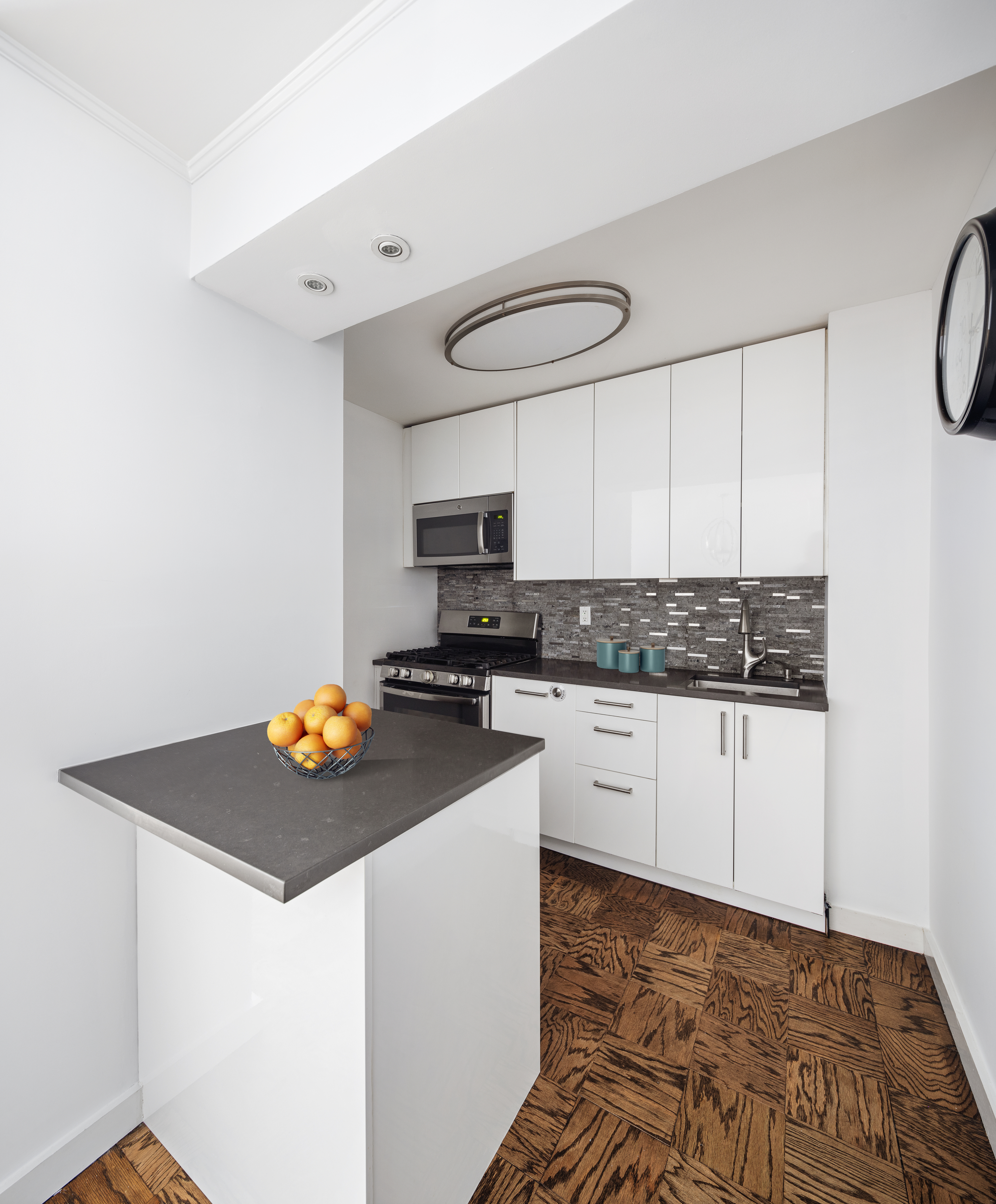 333 East 79th Street, Unit 4R Manhattan, NY 10075 - Photo 5 of 7 a kitchen with a sink appliances and cabinets
