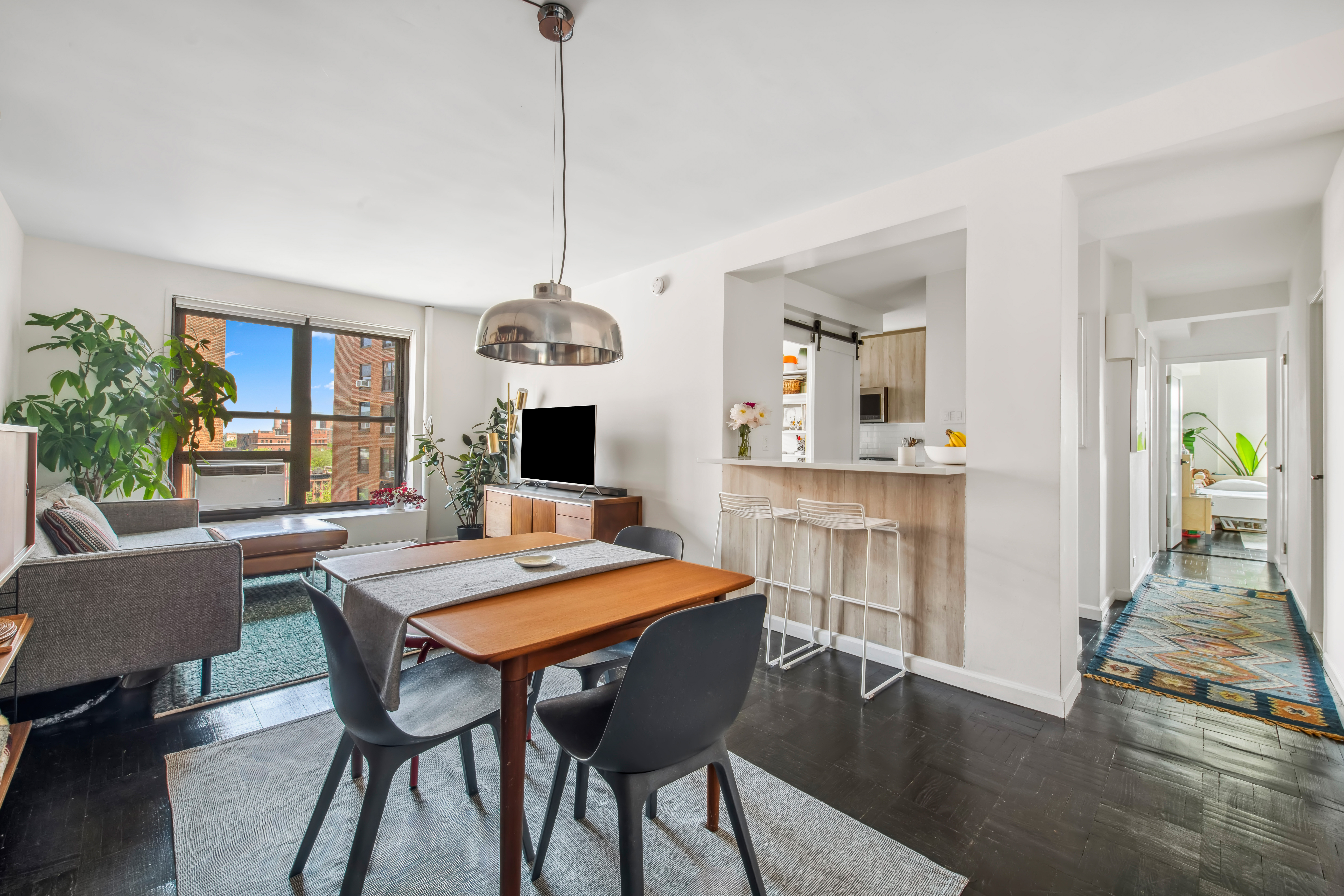 a view of a dining room with furniture window and wooden floor