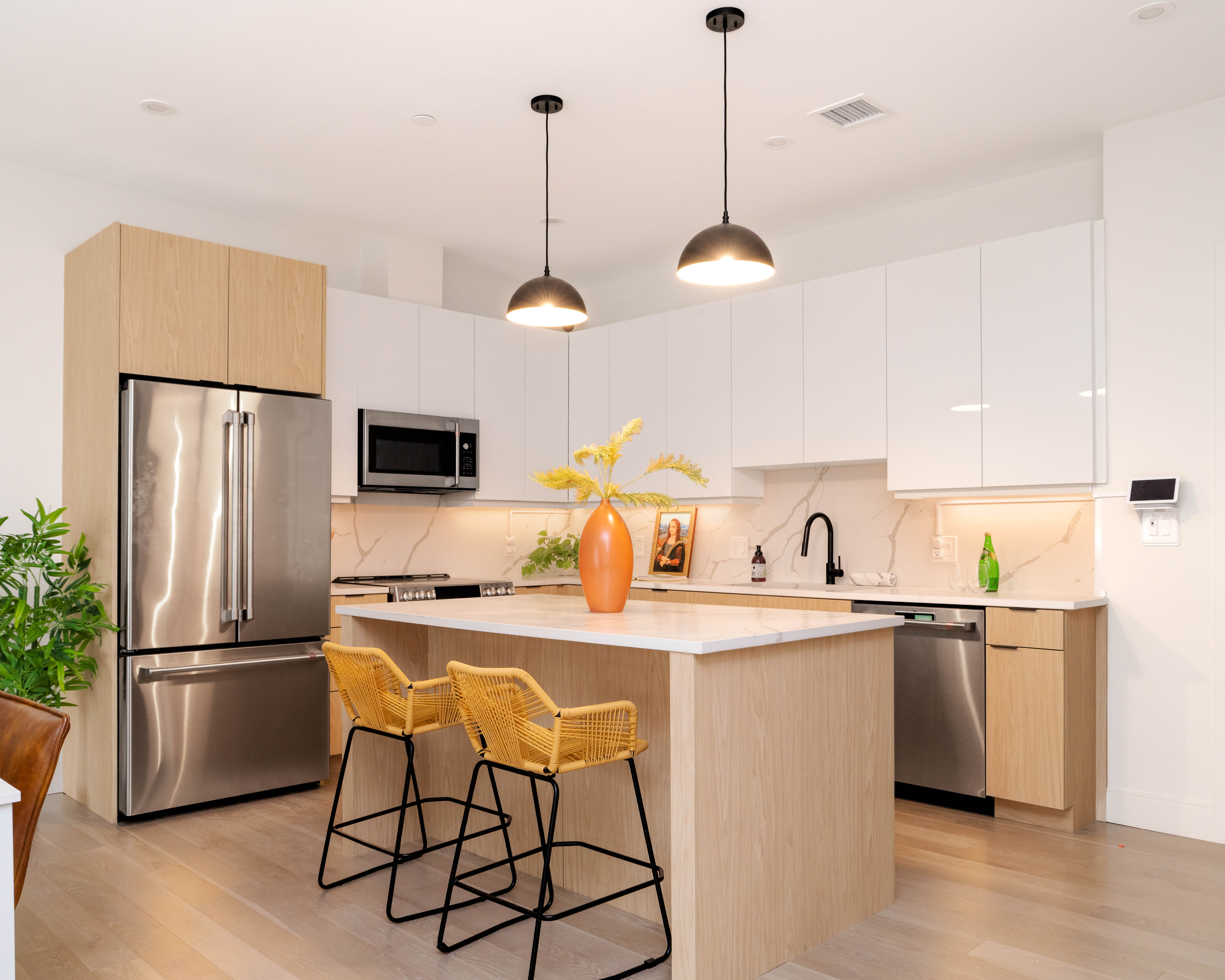 85 Myrtle Street, Unit 110 Quincy, MA 02171 - Photo 5 of 13 a kitchen with stainless steel appliances granite countertop a sink a stove a refrigerator a center island with wooden floor and cabinets