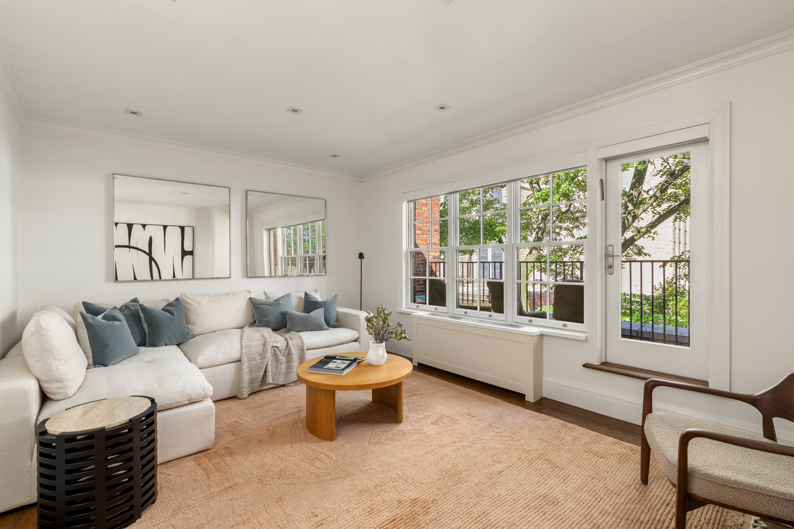 157 East 65th Street Manhattan, NY 10065 - Photo 19 of 28 a living room with furniture and a large window