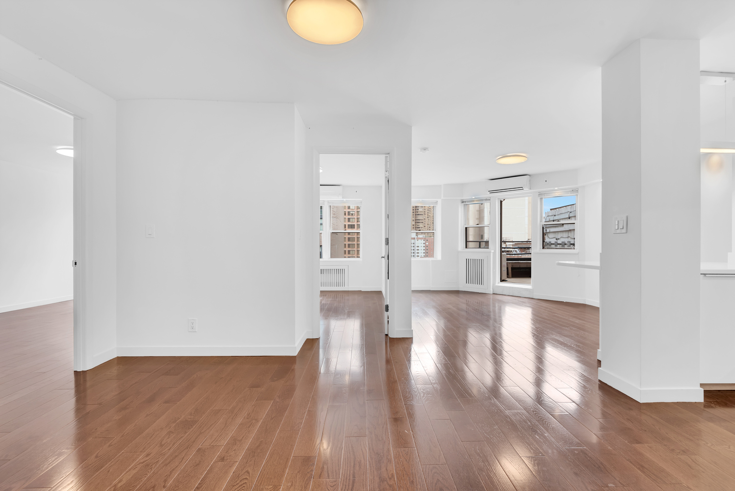 155 East 38th Street, Unit 18E Manhattan, NY 10016 - Photo 3 of 8 a view of a kitchen with wooden floor and a window