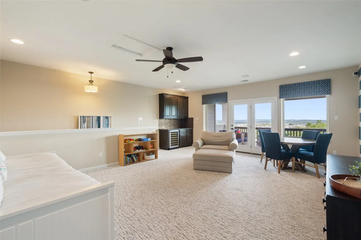 a living room with furniture and a flat screen tv with kitchen view