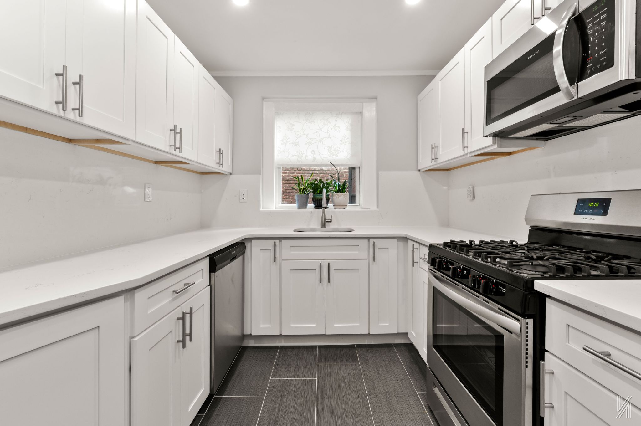 34-41 85th Street, Unit 1X Queens, NY 11372 - Photo 9 of 24 a kitchen with white cabinets stainless steel appliances and sink