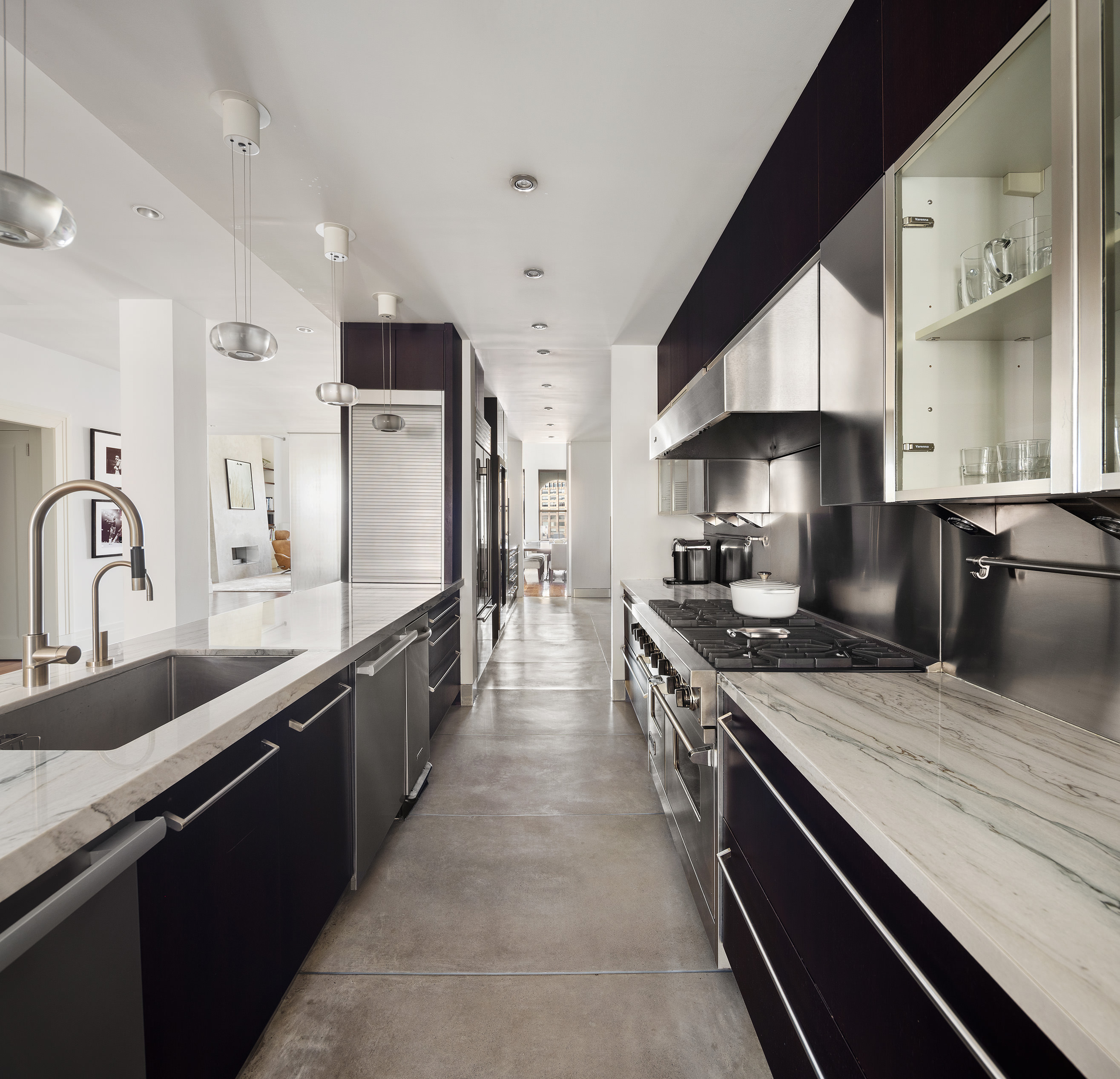 27 North Moore Street, Unit 10D Manhattan, NY 10013 - Photo 12 of 30 a large kitchen with stainless steel appliances a sink a stove and cabinets