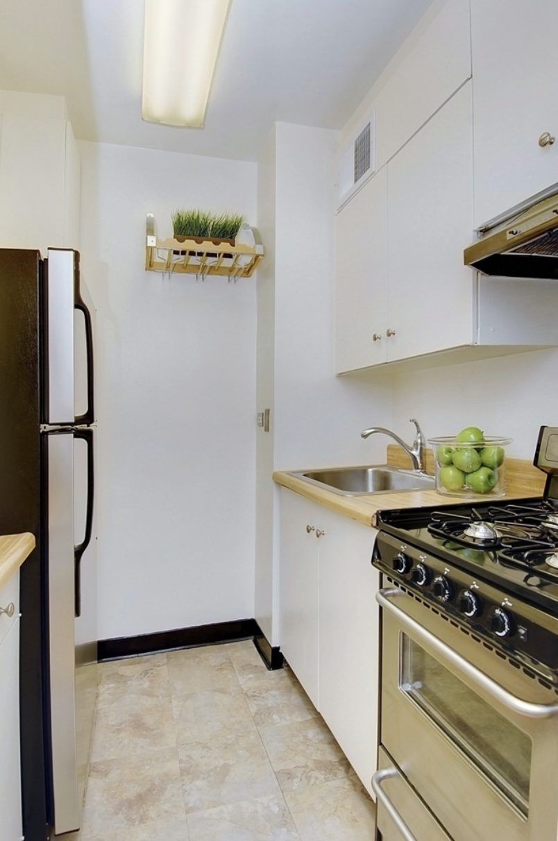 159 West 53rd Street, Unit 36C Manhattan, NY 10019 - Photo 3 of 9 a kitchen with a stove and a refrigerator