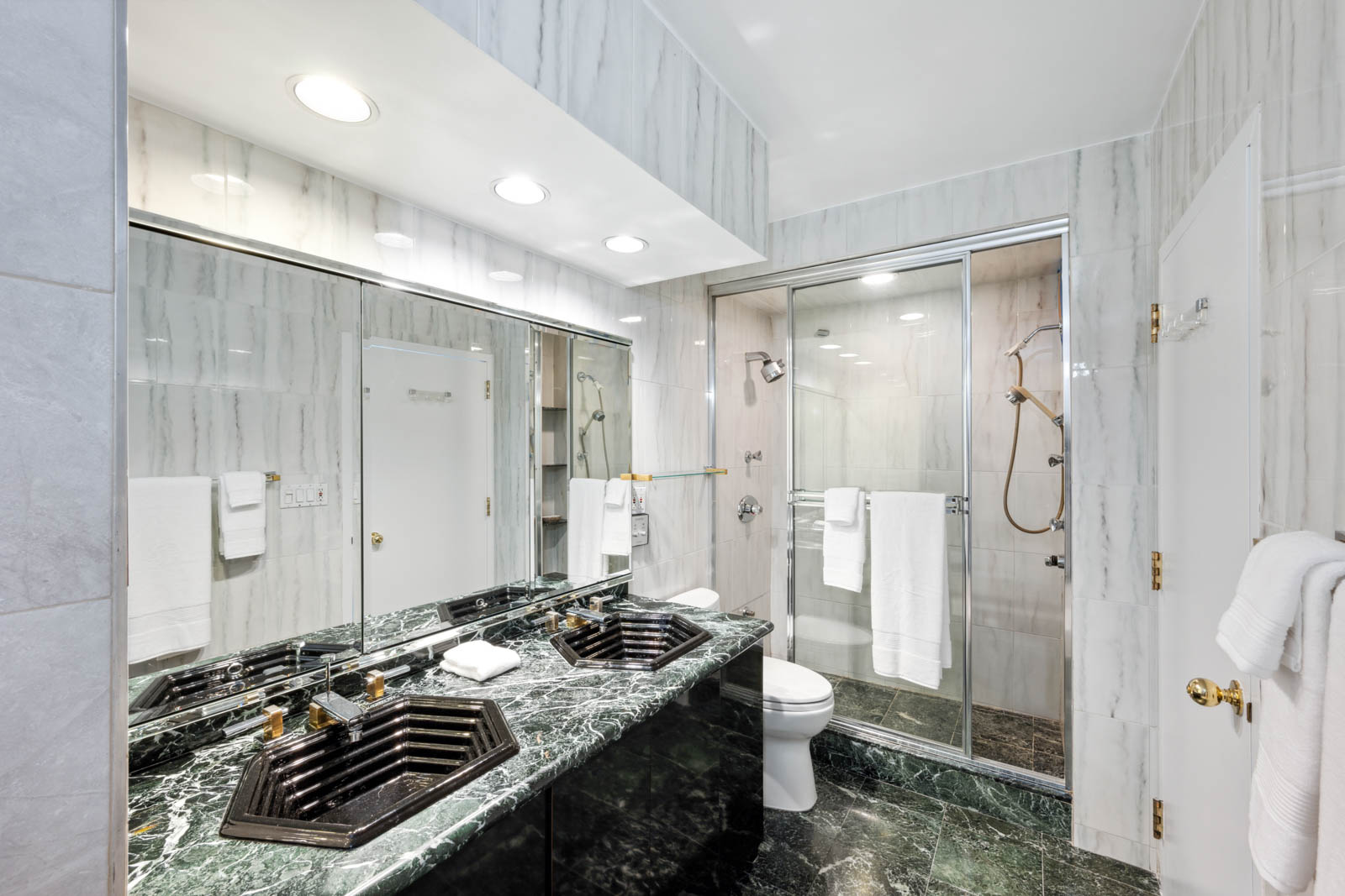 300 East 54th Street, Unit 34GF Manhattan, NY 10022 - Photo 8 of 16 a bathroom with a granite countertop sink a toilet and shower