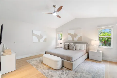 a bedroom with bed and a large window