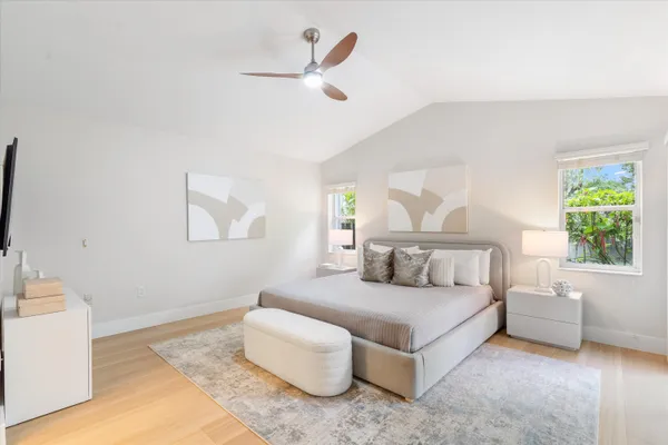 a bedroom with bed and a large window