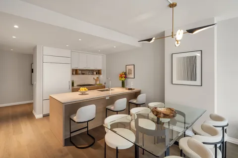 a view of a dining room with furniture wooden floor and chandelier