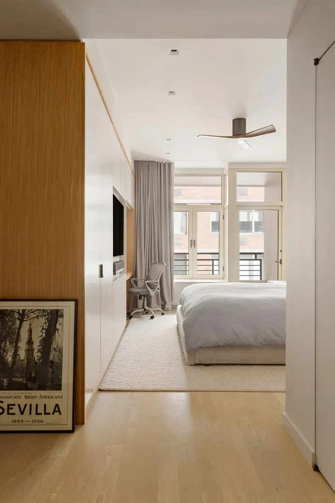 a living room with a bed furniture and next to a window