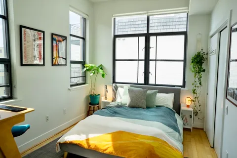 a bedroom with a bed and a window