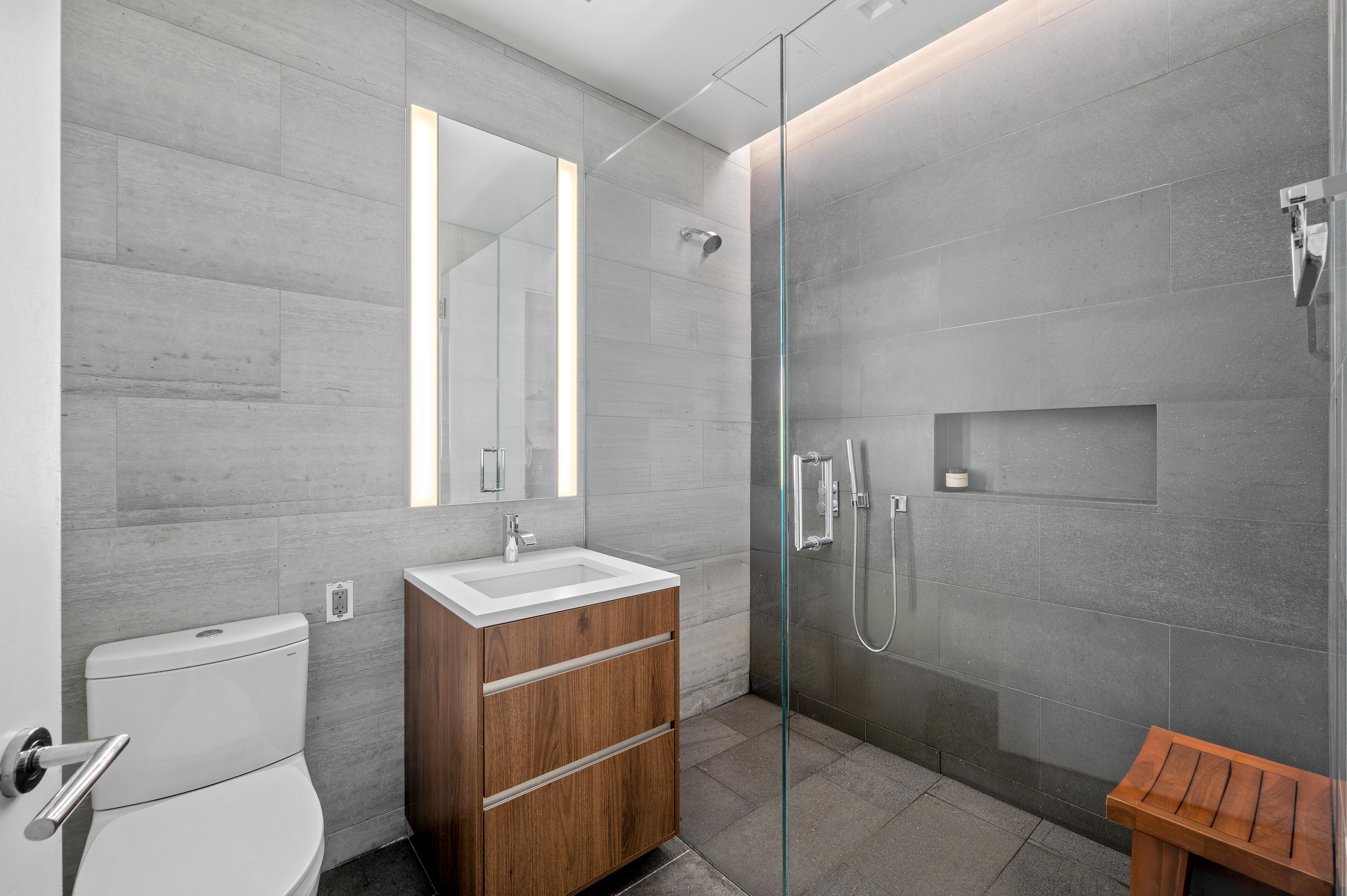 21-21 31st Street, Unit 5H Queens, NY 11105 - Photo 6 of 7 a bathroom with a sink toilet and shower