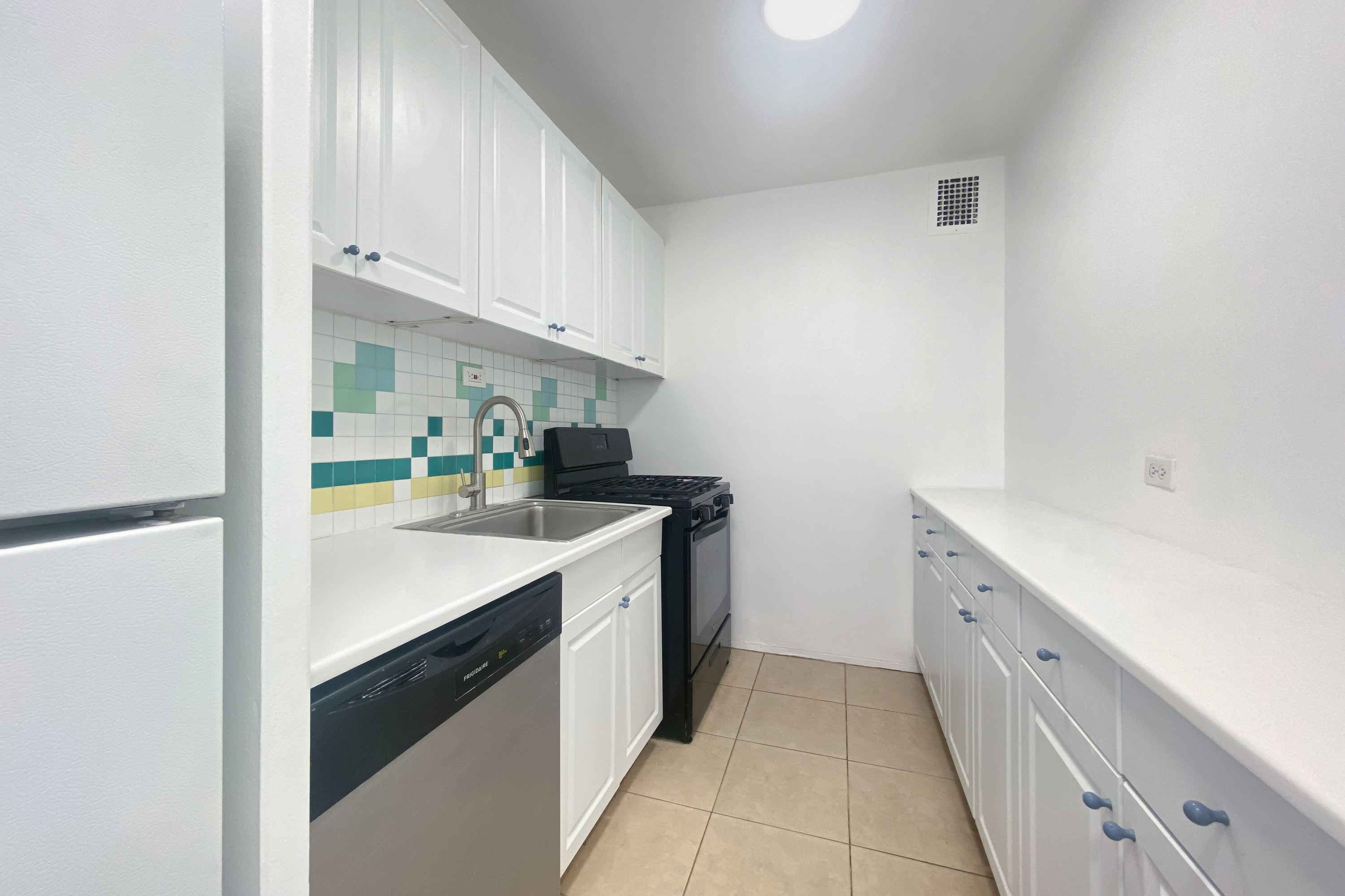 343 East 30th Street, Unit 19K Manhattan, NY 10016 - Photo 8 of 22 a kitchen with white cabinets and white appliances