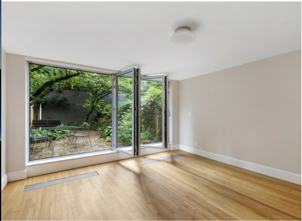 128 State Street, Unit GARDEN Brooklyn, NY 11201 - Photo 2 of 10 a view of an empty room with wooden floor and a window
