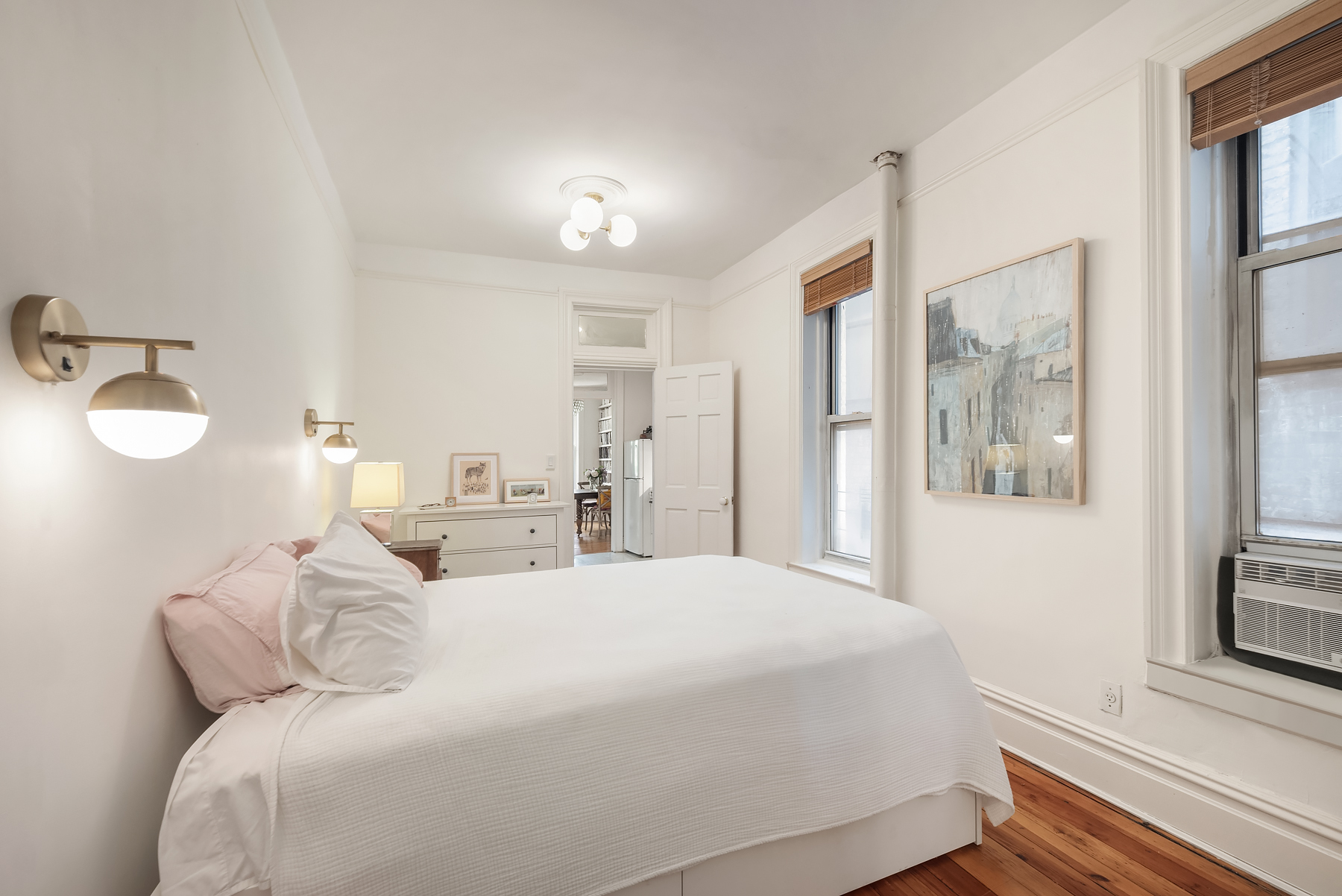 84 Charles Street, Unit 13 Manhattan, NY 10014 - Photo 6 of 8 a bedroom with a bed and a window