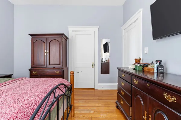 a bedroom with a bed and a flat screen tv
