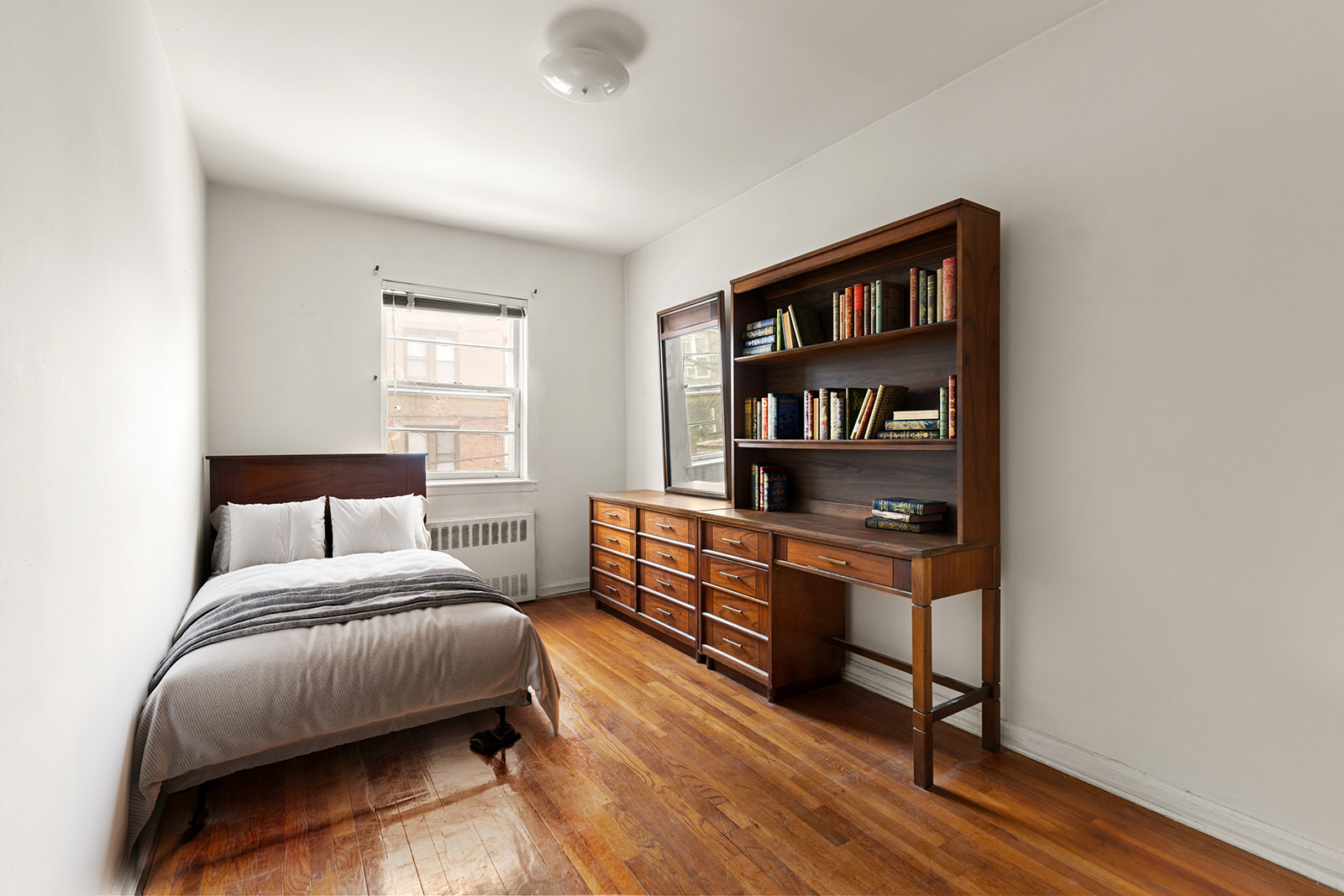 612 17th Street Brooklyn, NY 11218 - Photo 4 of 12 a bed room with a bed and a book shelf