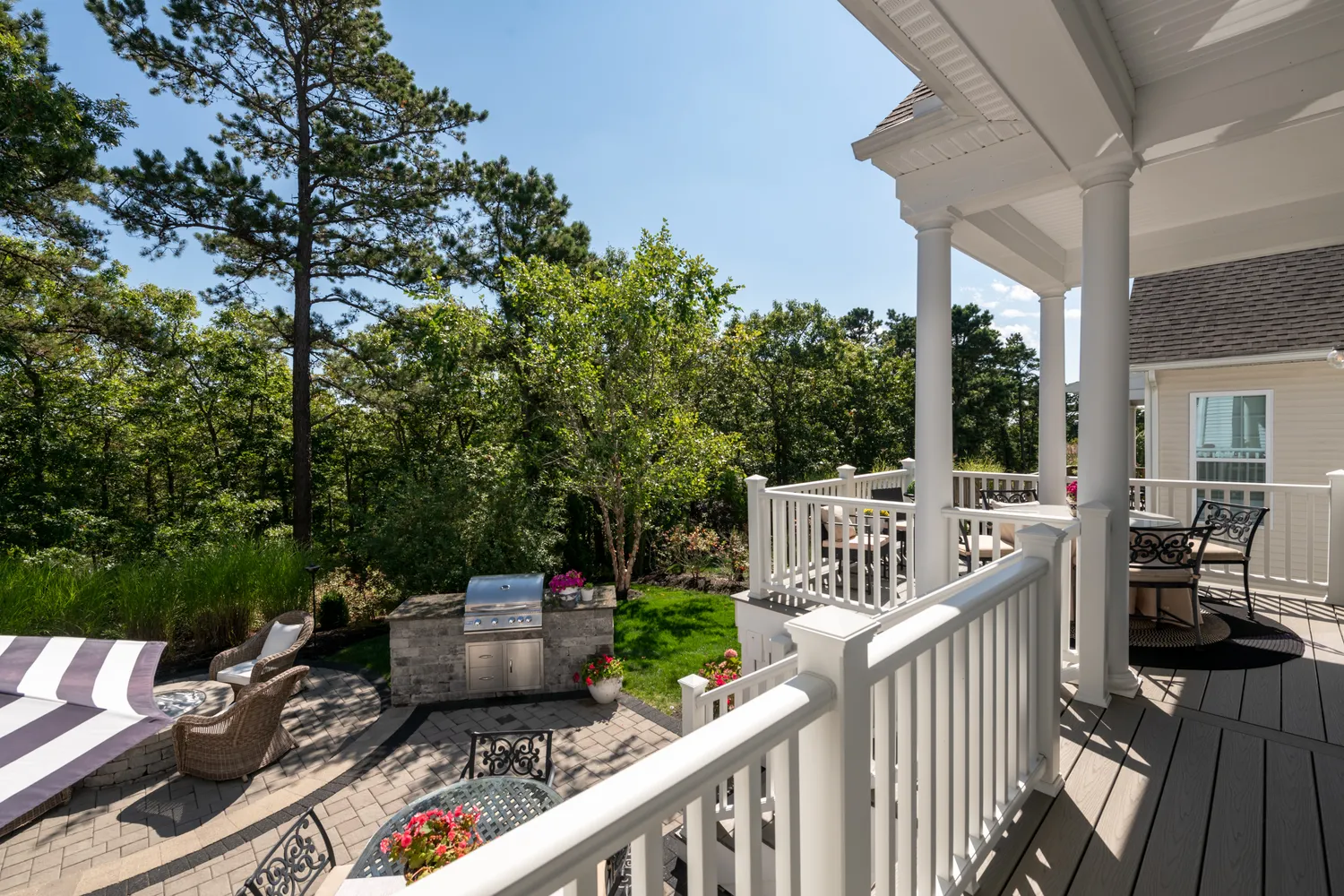 a view of a deck with two couches chairs with wooden fence