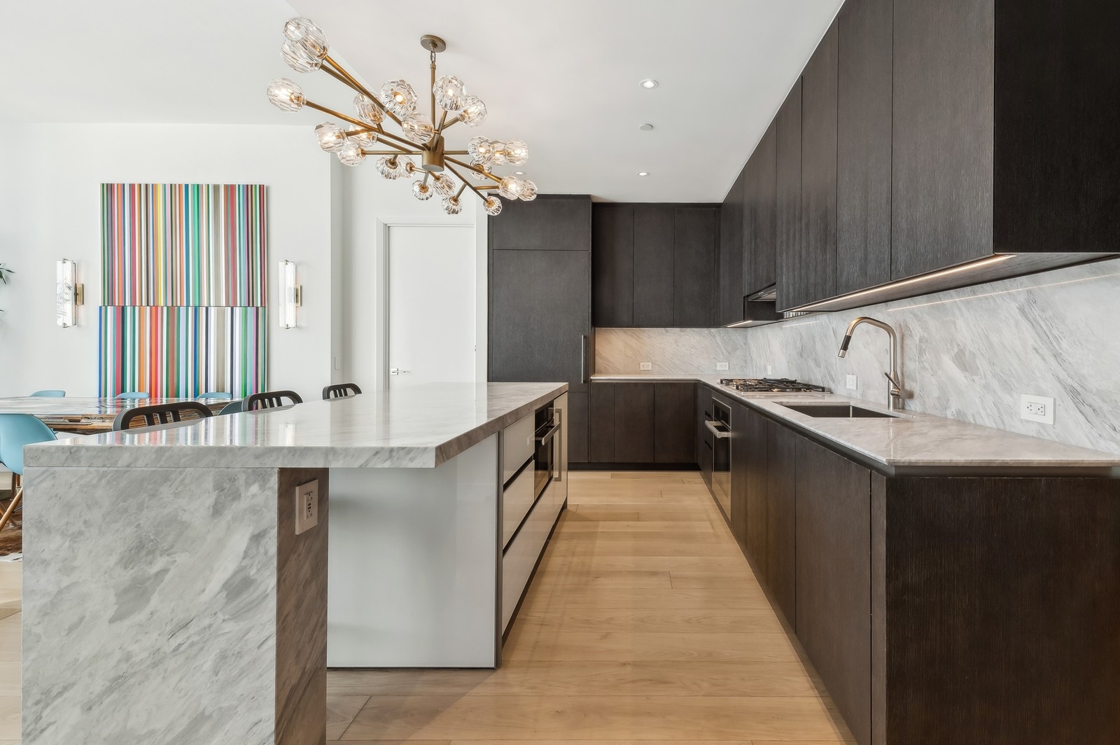 15 Hudson Yards, Unit 74F Manhattan, NY 10001 - Photo 5 of 13 a kitchen with stainless steel appliances a sink stove and cabinets