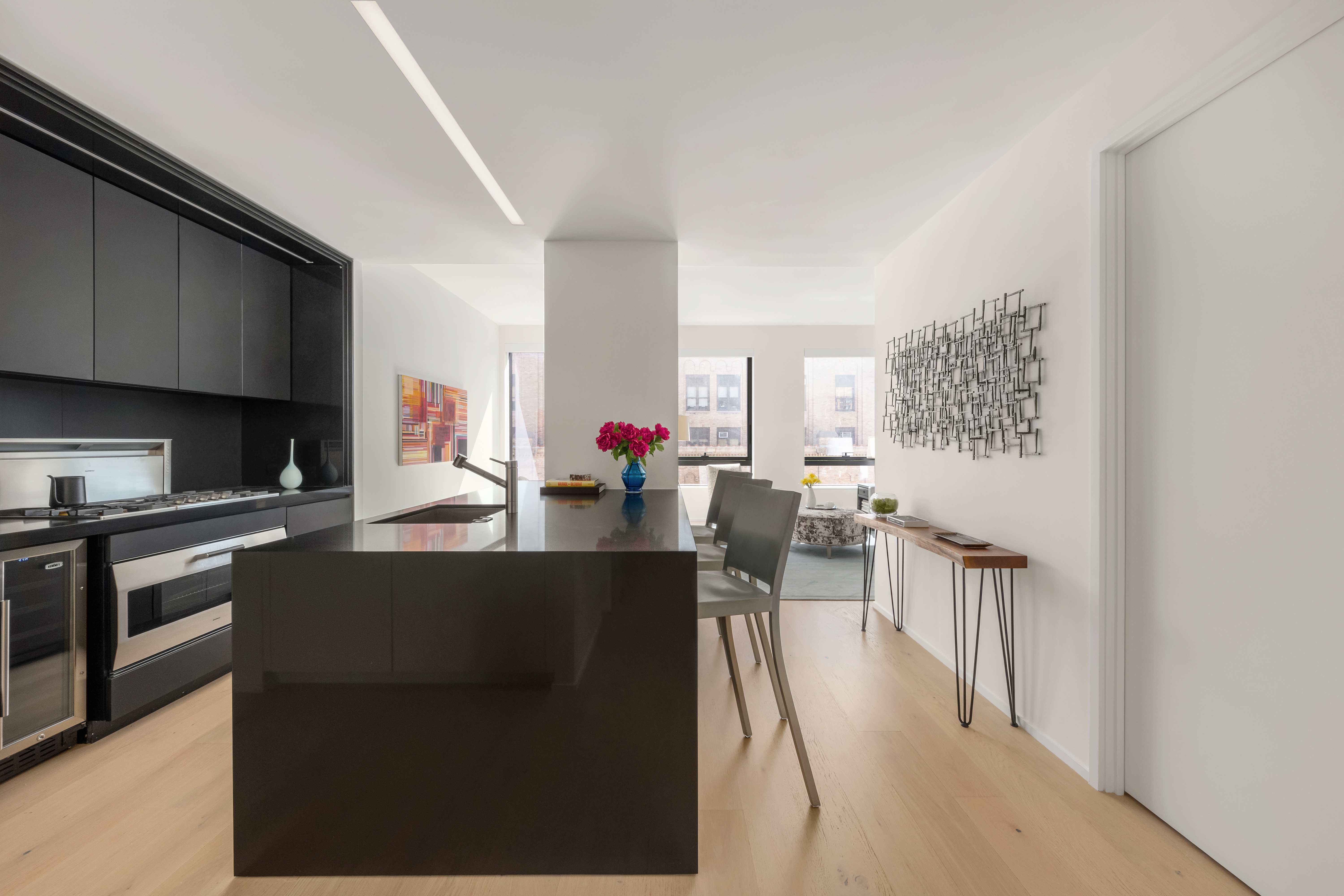 121 East 22nd Street, Unit N1405 Manhattan, NY 10010 - Photo 4 of 19 a living room with furniture a flat screen tv and a refrigerator