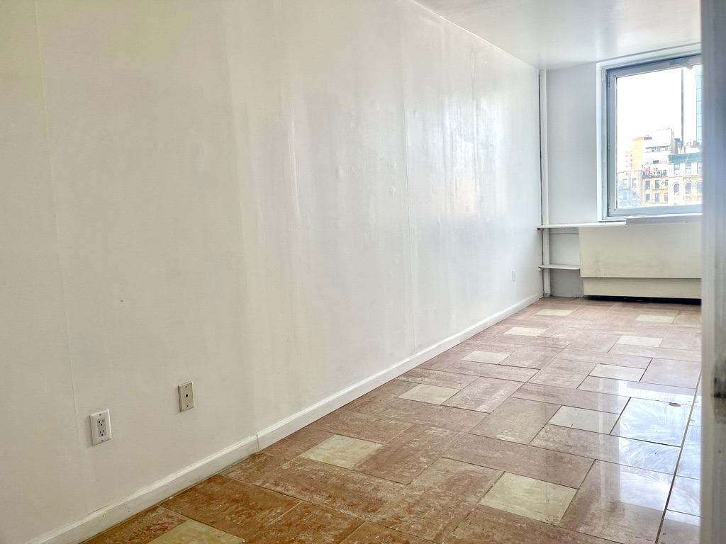 148A Madison Street, Unit 4 Manhattan, NY 10002 - Photo 8 of 13 a view of an empty room with a window