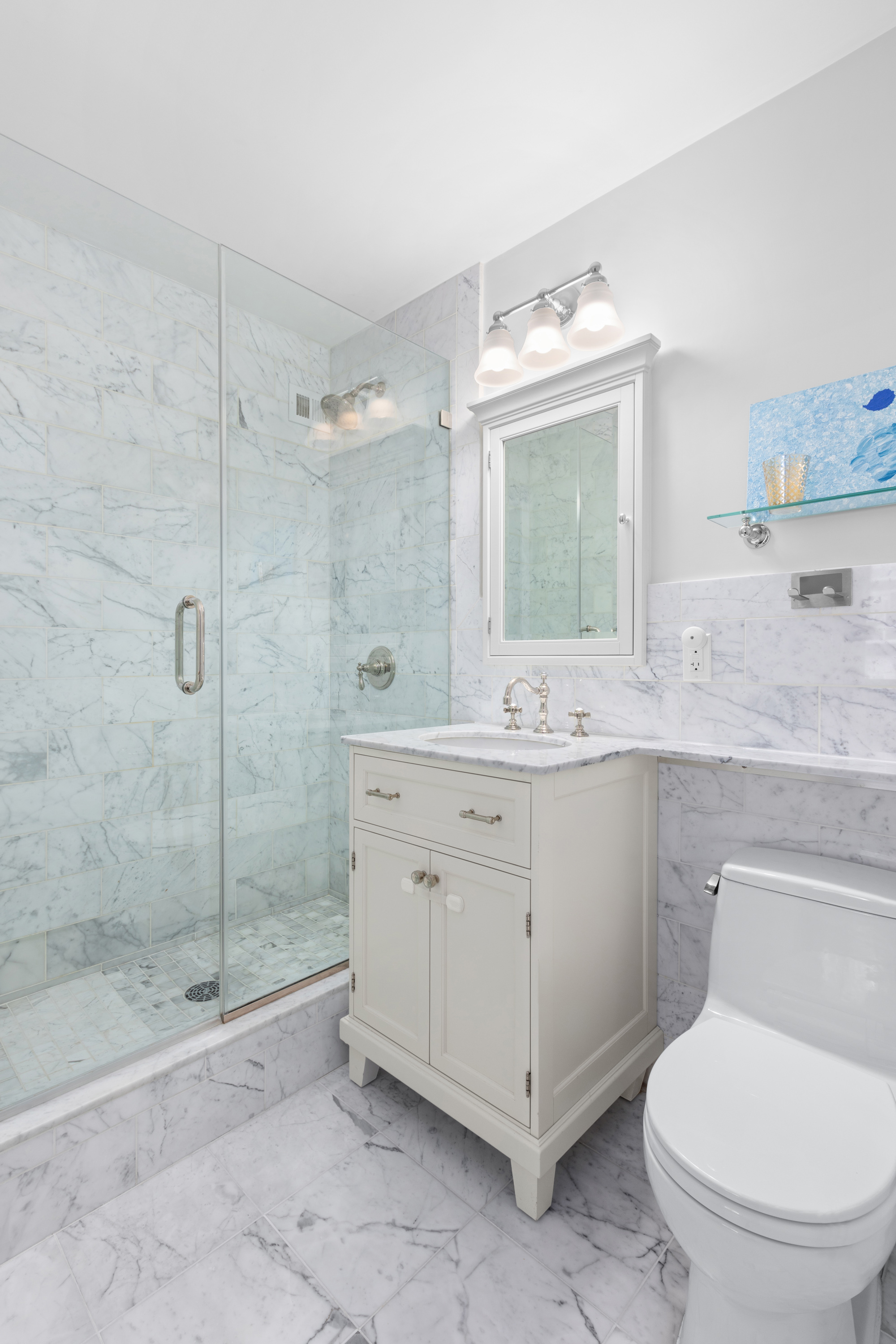 575 Main Street, Unit 509 Manhattan, NY 10044 - Photo 11 of 25 a bathroom with a granite countertop sink mirror and toilet
