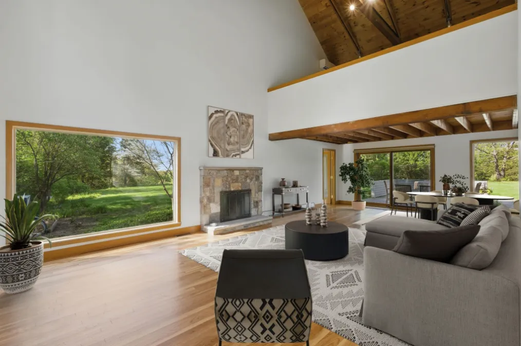 a living room with fireplace furniture and a large window