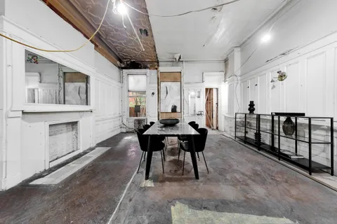 a living room with furniture a wooden floor and a chandelier