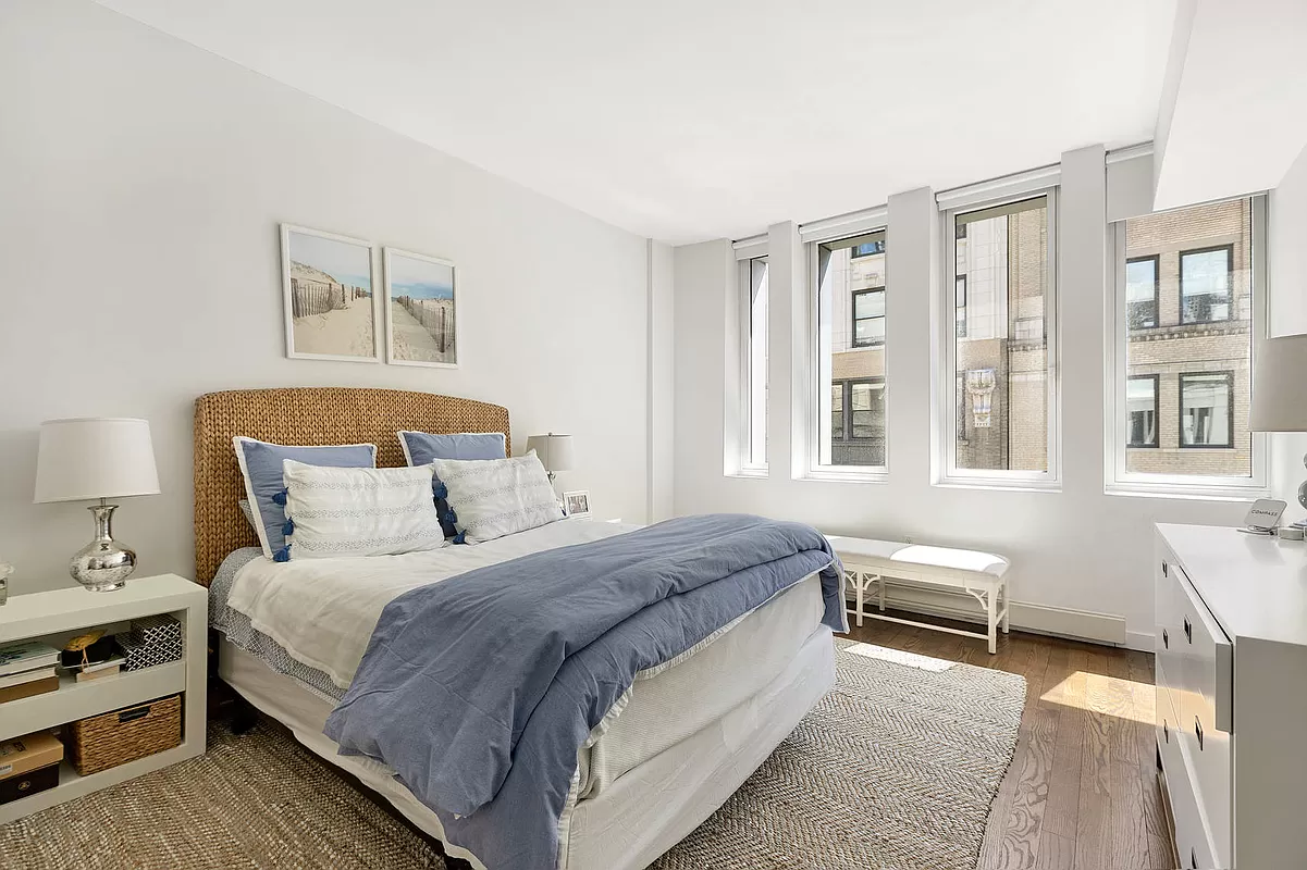 133 West 22nd Street, Unit 12B Manhattan, NY 10011 - Photo 6 of 12 a bedroom with a bed and wooden floor