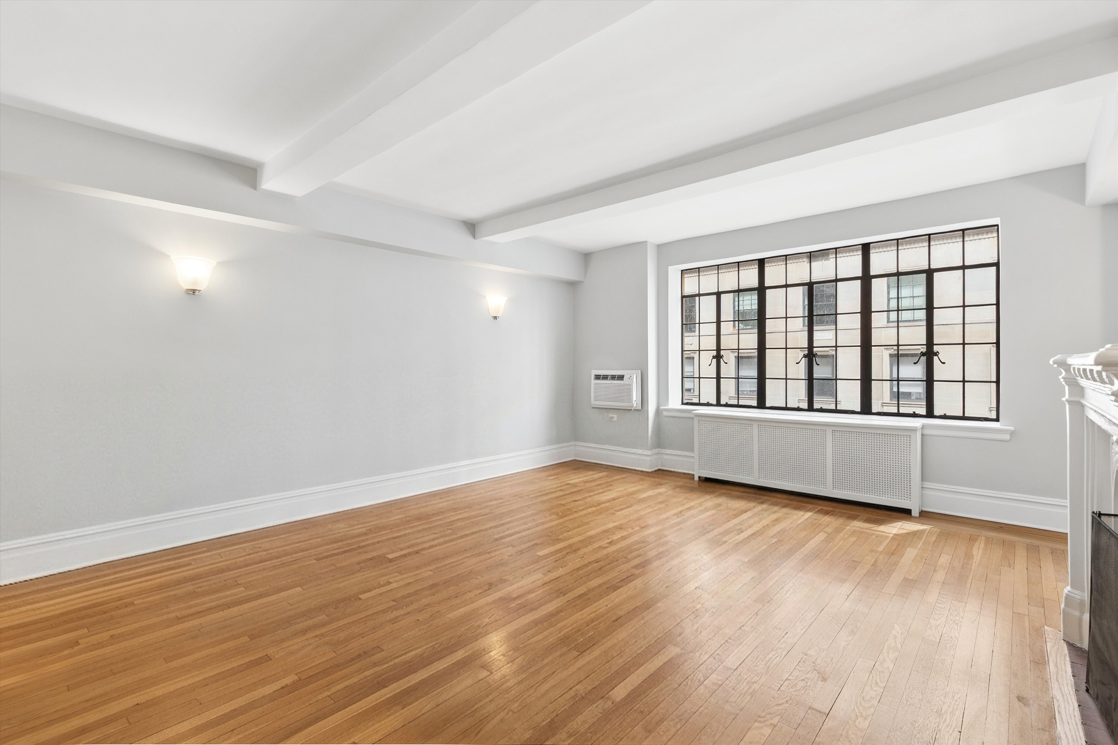 444 East 52nd Street, Unit 3C Manhattan, NY 10022 - Photo 4 of 19 wooden floor in an empty room with a window