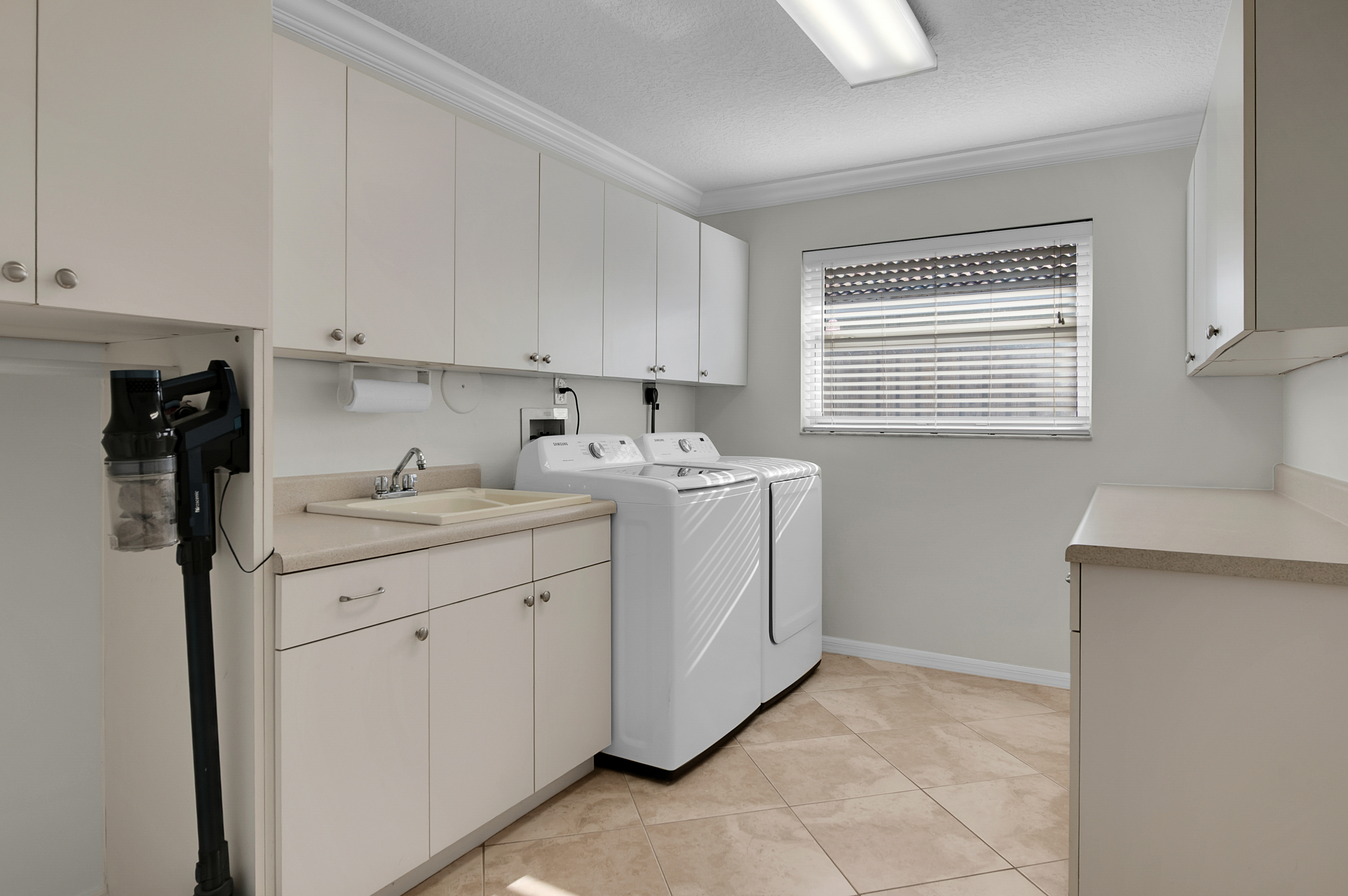 1560 Southwest 16th Street Boca Raton, FL 33486 - Photo 48 of 72 a utility room with cabinets washer and dryer