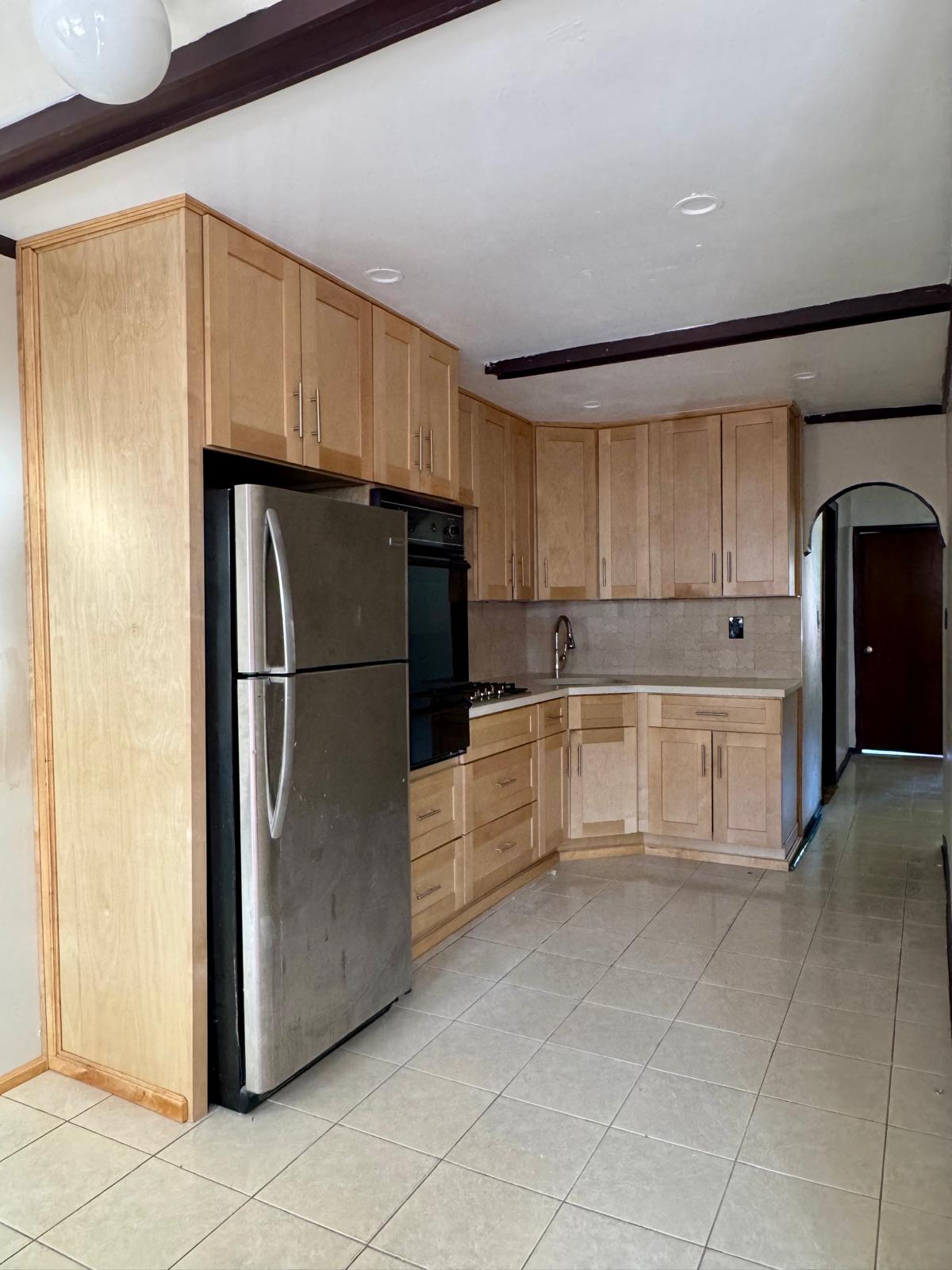 647 East 82nd Street, Unit 2 Brooklyn, NY 11236 - Photo 2 of 6 a kitchen with white cabinets and stainless steel appliances