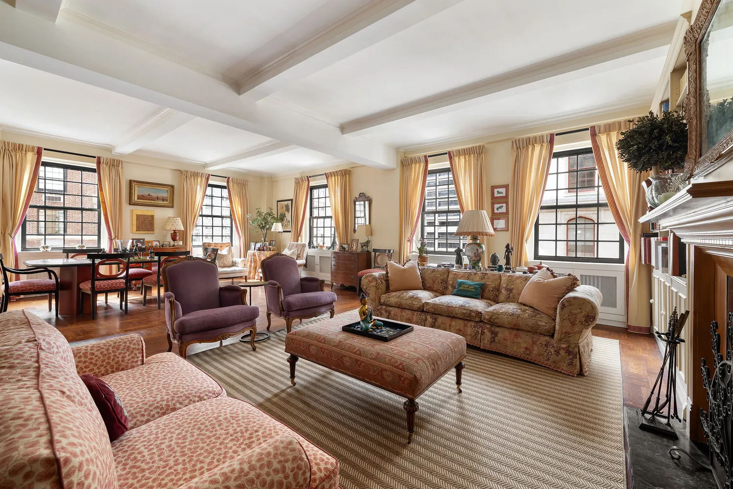 a living room with furniture fireplace and a large window
