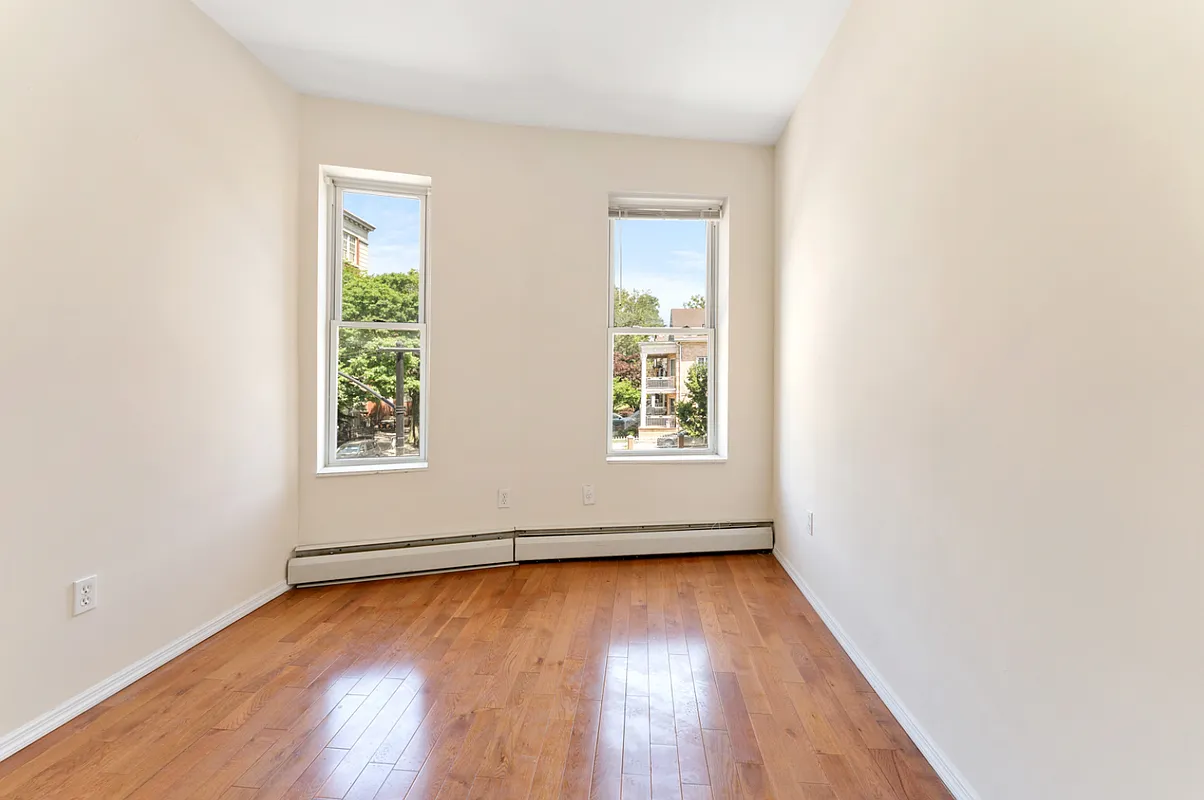 1402 Cortelyou Road, Unit 4 Brooklyn, NY 11226 - Photo 3 of 5 an empty room with wooden floor and windows