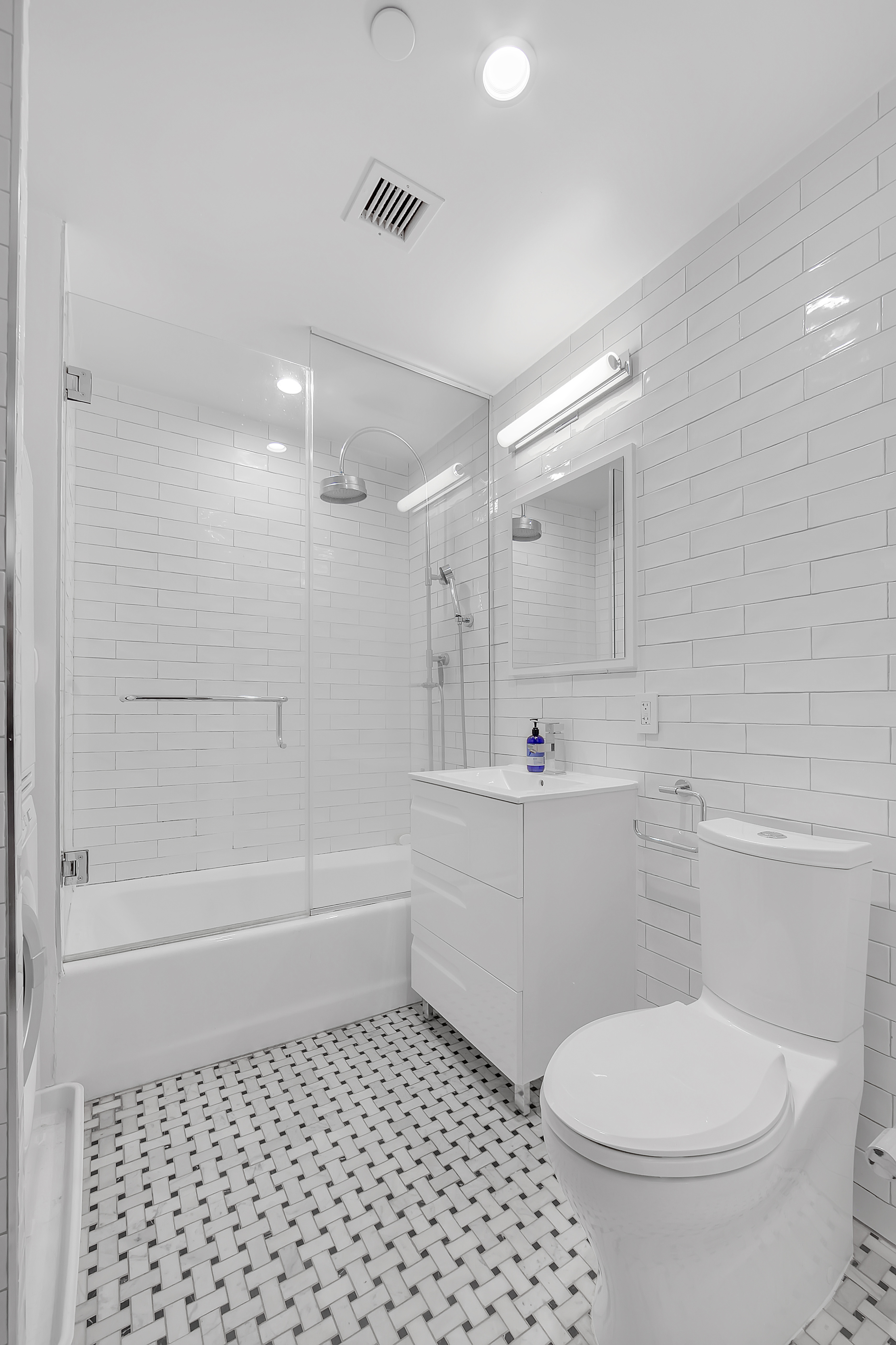 a bathroom with a toilet a sink and shower