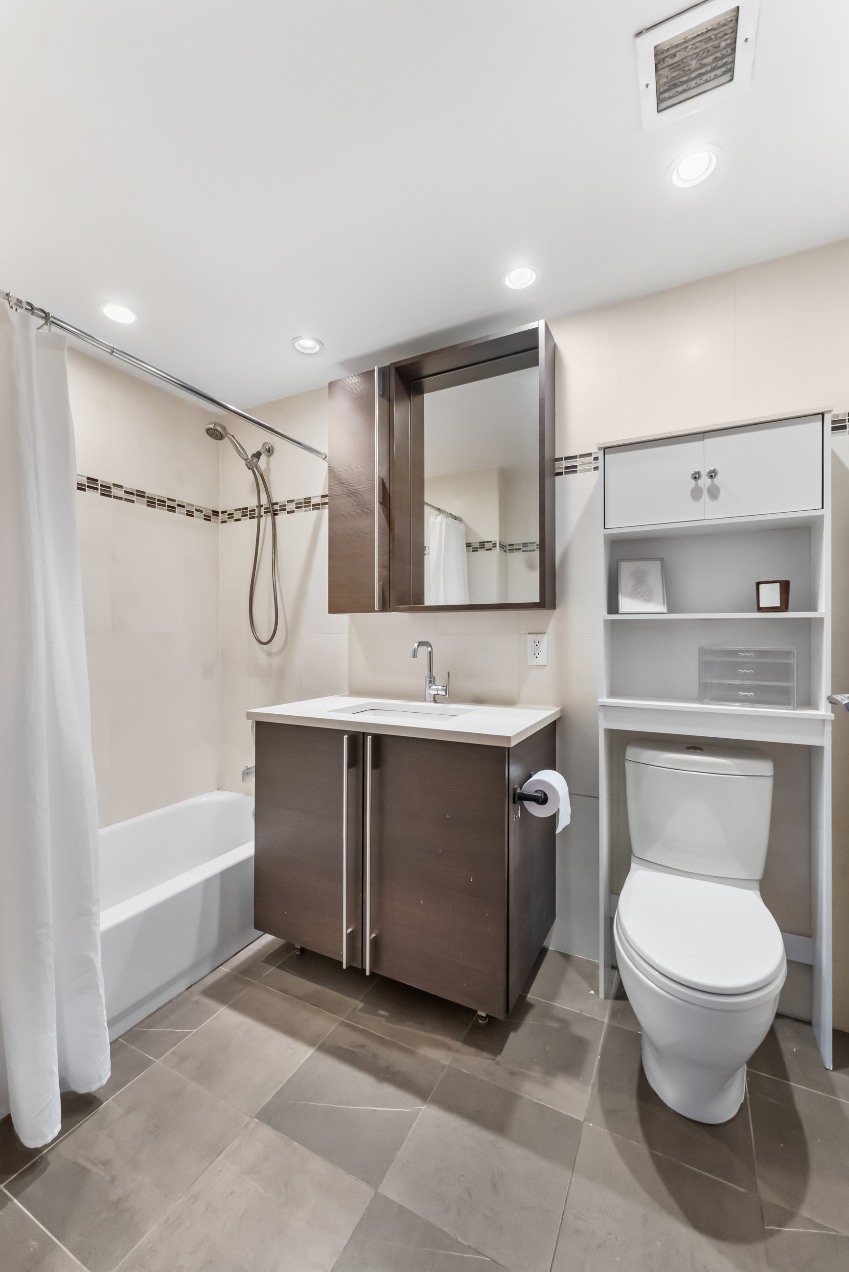 31-35 31st Street, Unit 512 Queens, NY 11106 - Photo 5 of 6 a spacious bathroom with a toilet sink and shower