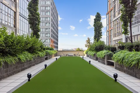 a view of a garden with a building in the background