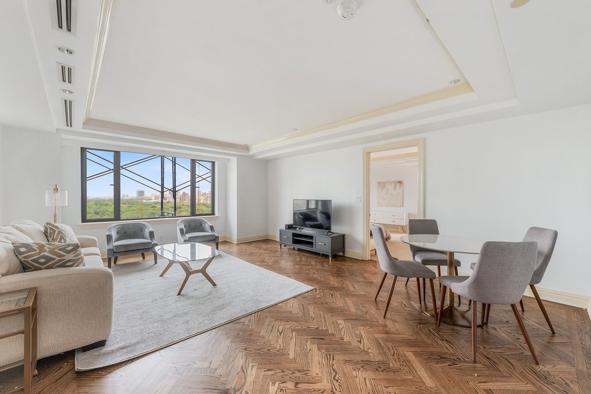 160 Central Park South, Unit 2101 Manhattan, NY 10019 - Photo 3 of 7 a living room with furniture and a large window
