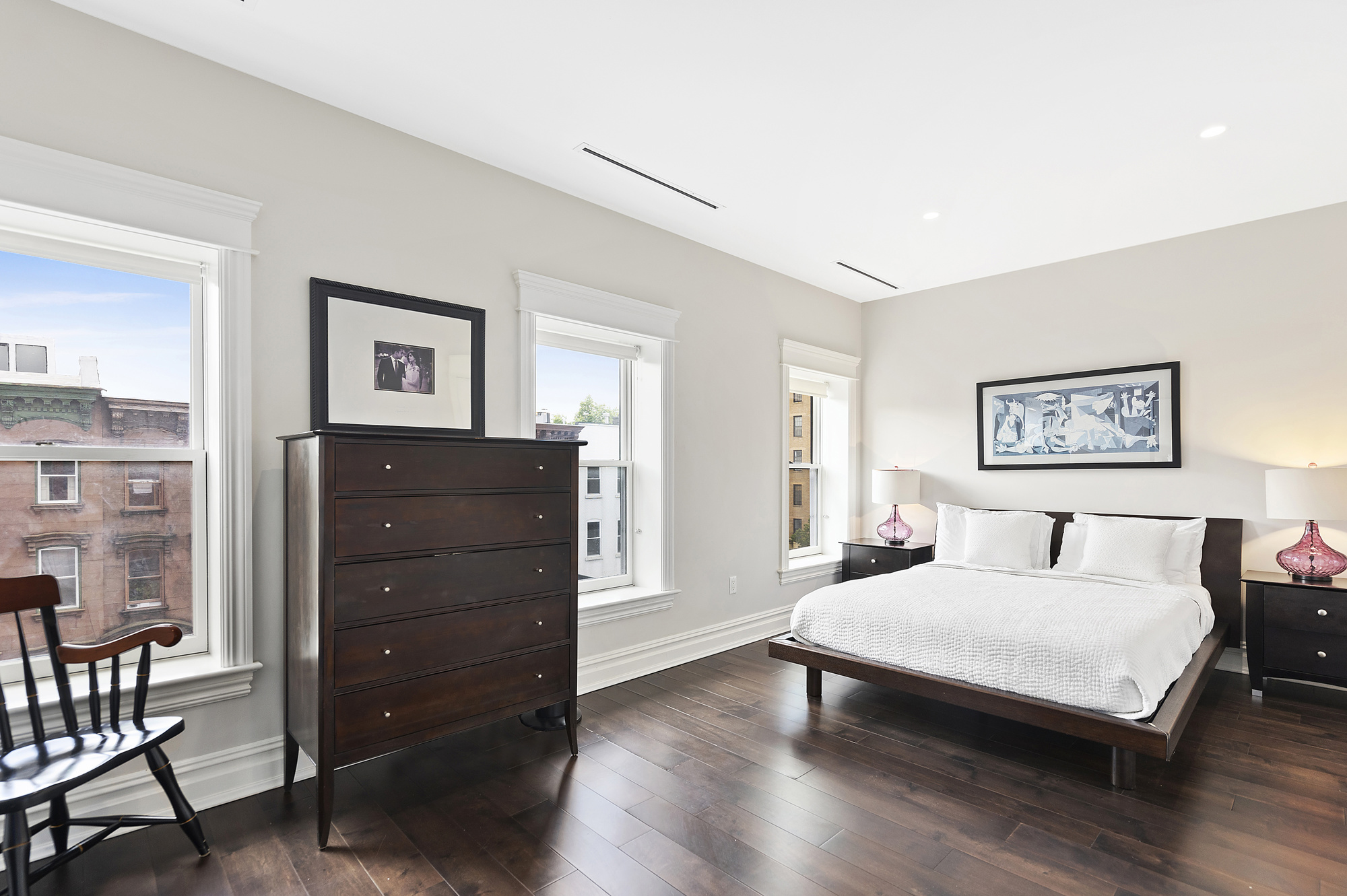 67 Greene Avenue, Unit 2 Brooklyn, NY 11238 - Photo 11 of 15 a bedroom with a bed and paintings on the wall