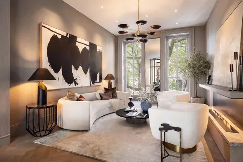 a living room with furniture and a large mirror