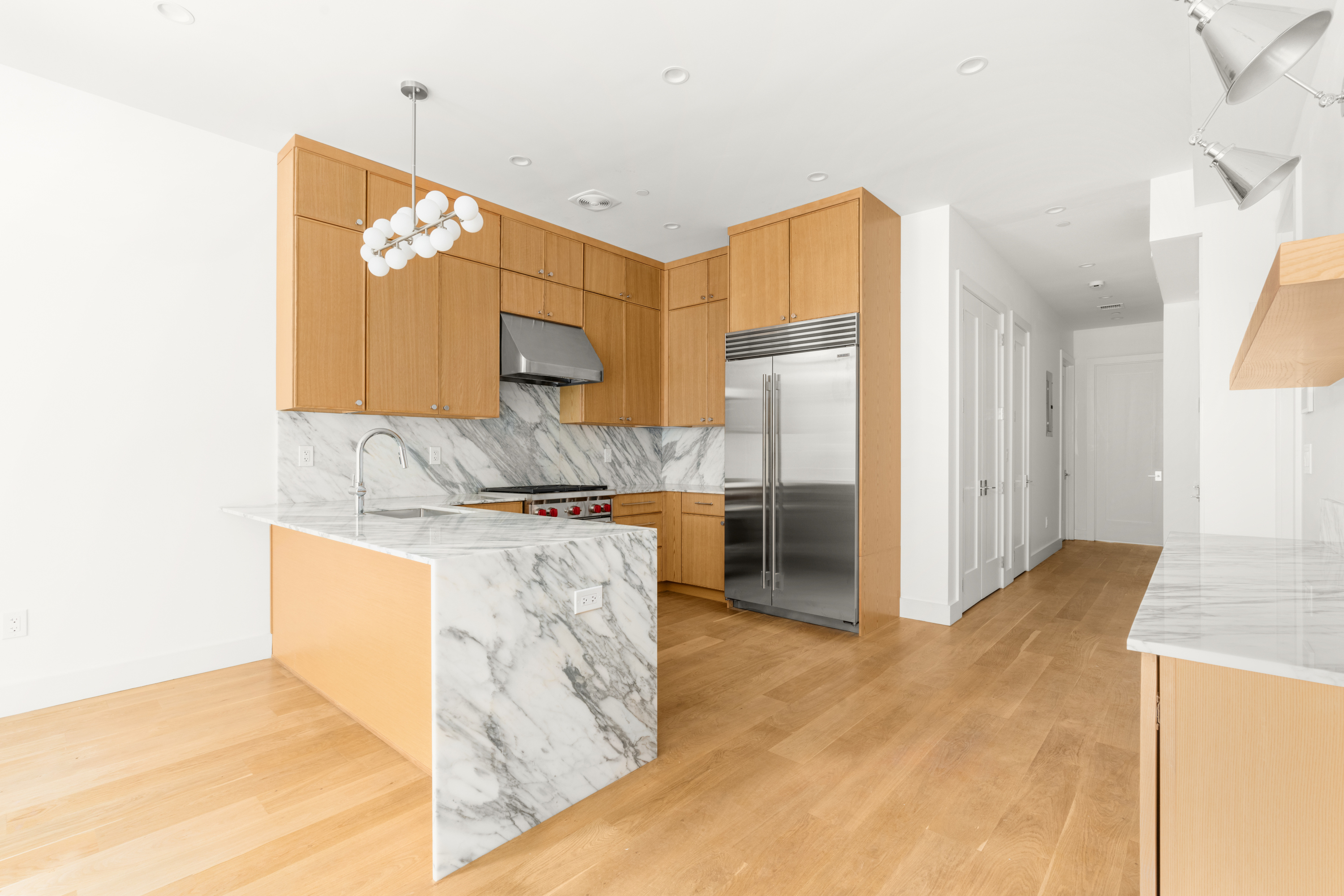 a kitchen with stainless steel appliances granite countertop a refrigerator and a stove