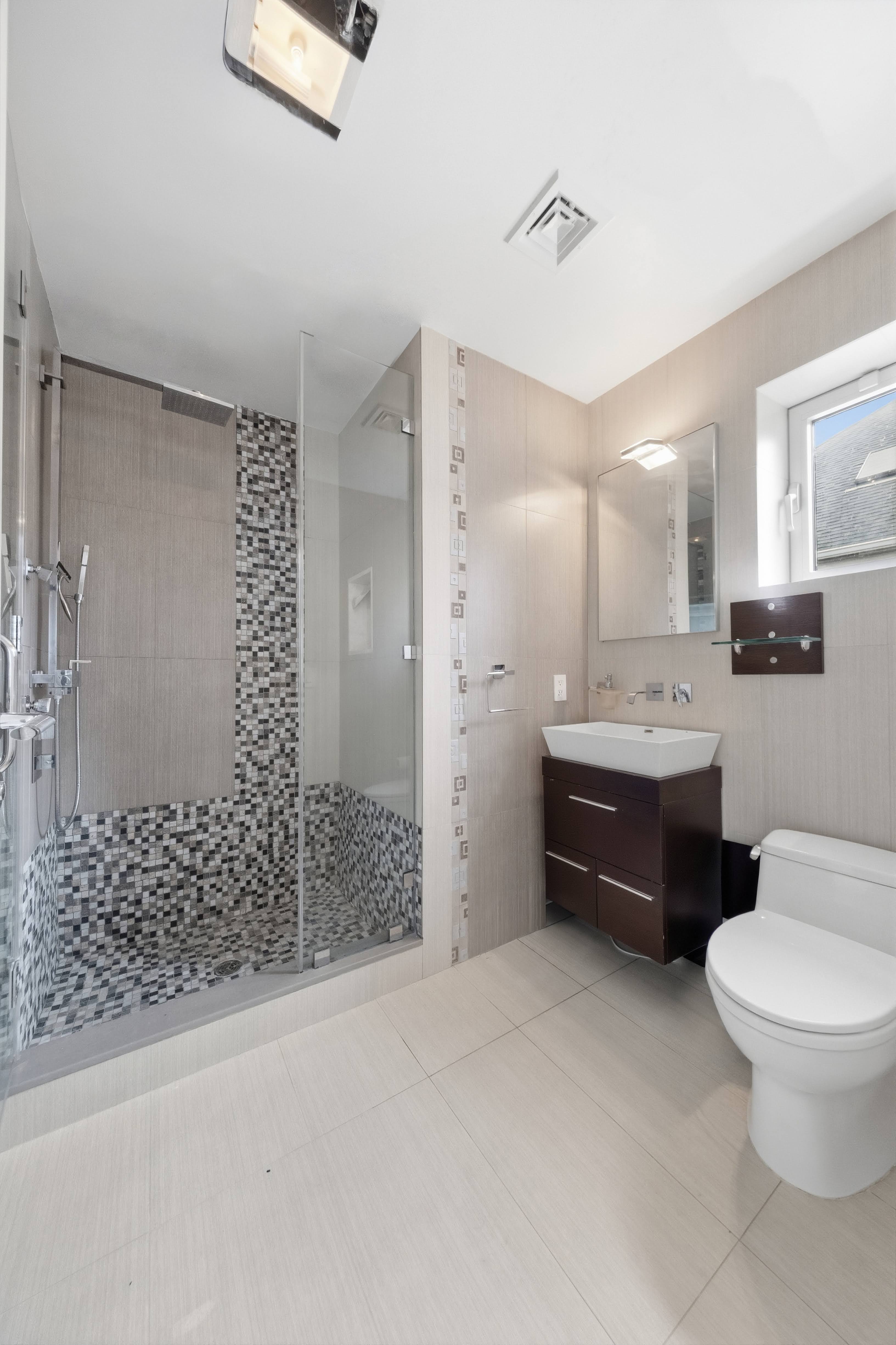 186 Flagg Place Staten Island, NY 10304 - Photo 44 of 44 a bathroom with a double vanity sink toilet and shower