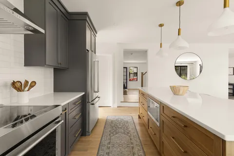 a kitchen with kitchen island a sink stove and refrigerator