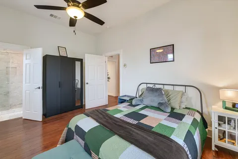 a bedroom with a bed and a chandelier
