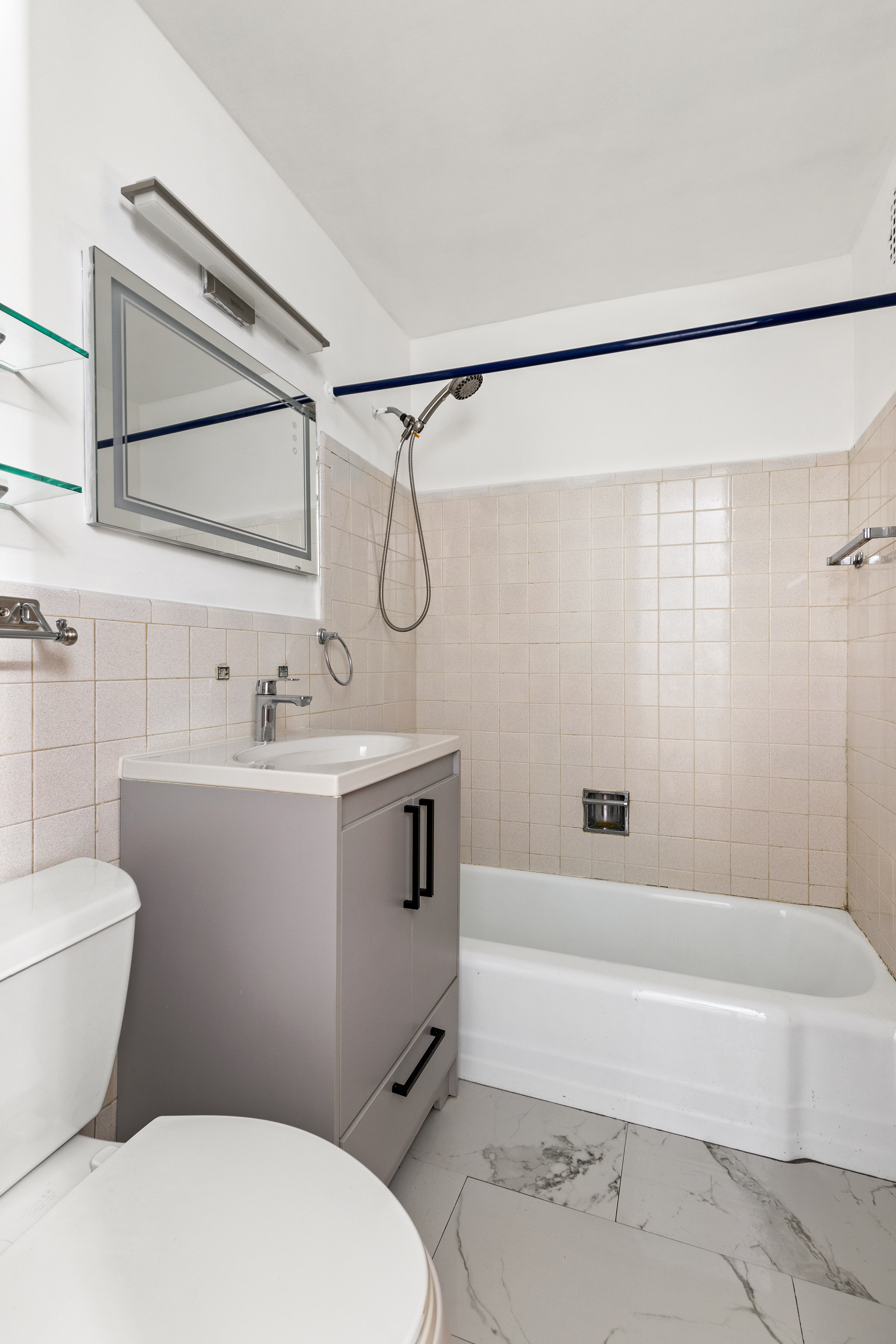 195 Willoughby Avenue, Unit 1612 Brooklyn, NY 11205 - Photo 6 of 10 a bathroom with a sink mirror vanity and toilet